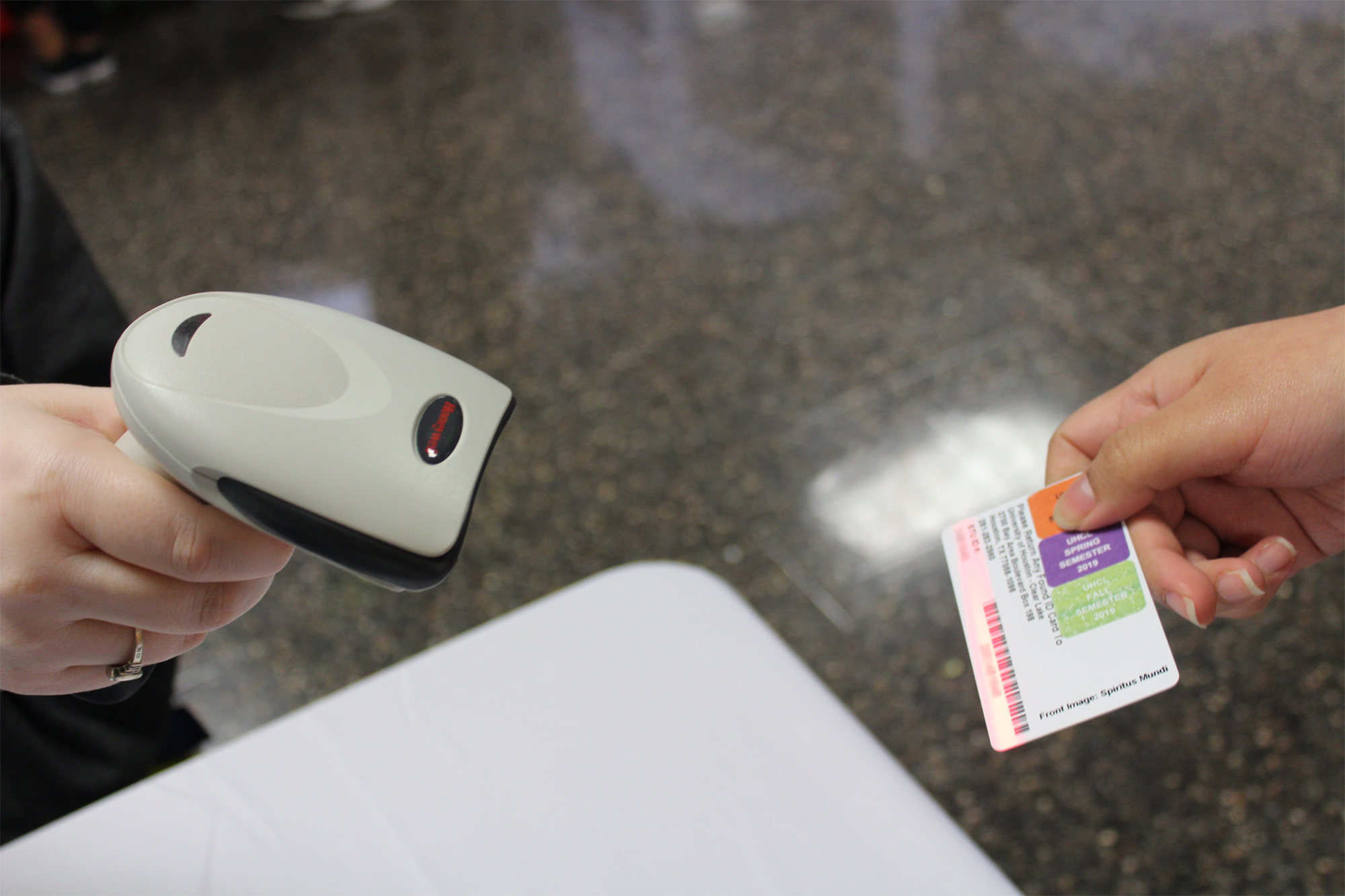 PHOTO: Student getting her identification card scanned to enter the event. Photo by: The Signal reporter Aimee Kubena.