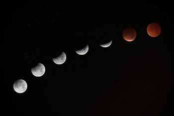 GRAPHIC: Phases of the moon throughout the lunar cycle portrayed against a black sky background.
