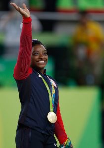 PHOTO: Simone Biles at the 2016 Rio Olympics. Photo courtesy of Agência Brasil on Flickr. SOURCE: https://en.wikipedia.org/wiki/File:Simone_Biles_at_the_2016_Olympics_all-around_gold_medal_podium_(28262782114).jpg
