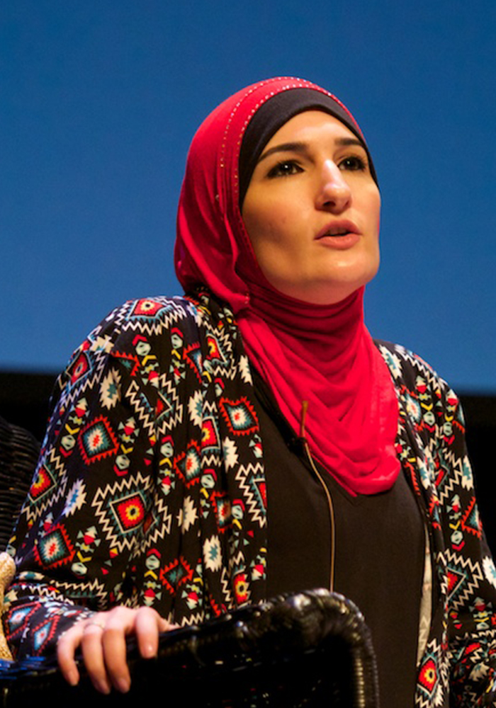 PHOTO: Linda Sarsour wearing a hot pink hijab while speaking about Islamophobia in 2016. Photo courtesy of Festival of Faiths on Flickr. SOURCE: https://www.flickr.com/photos/festoffaiths/27581877360/in/photostream/
