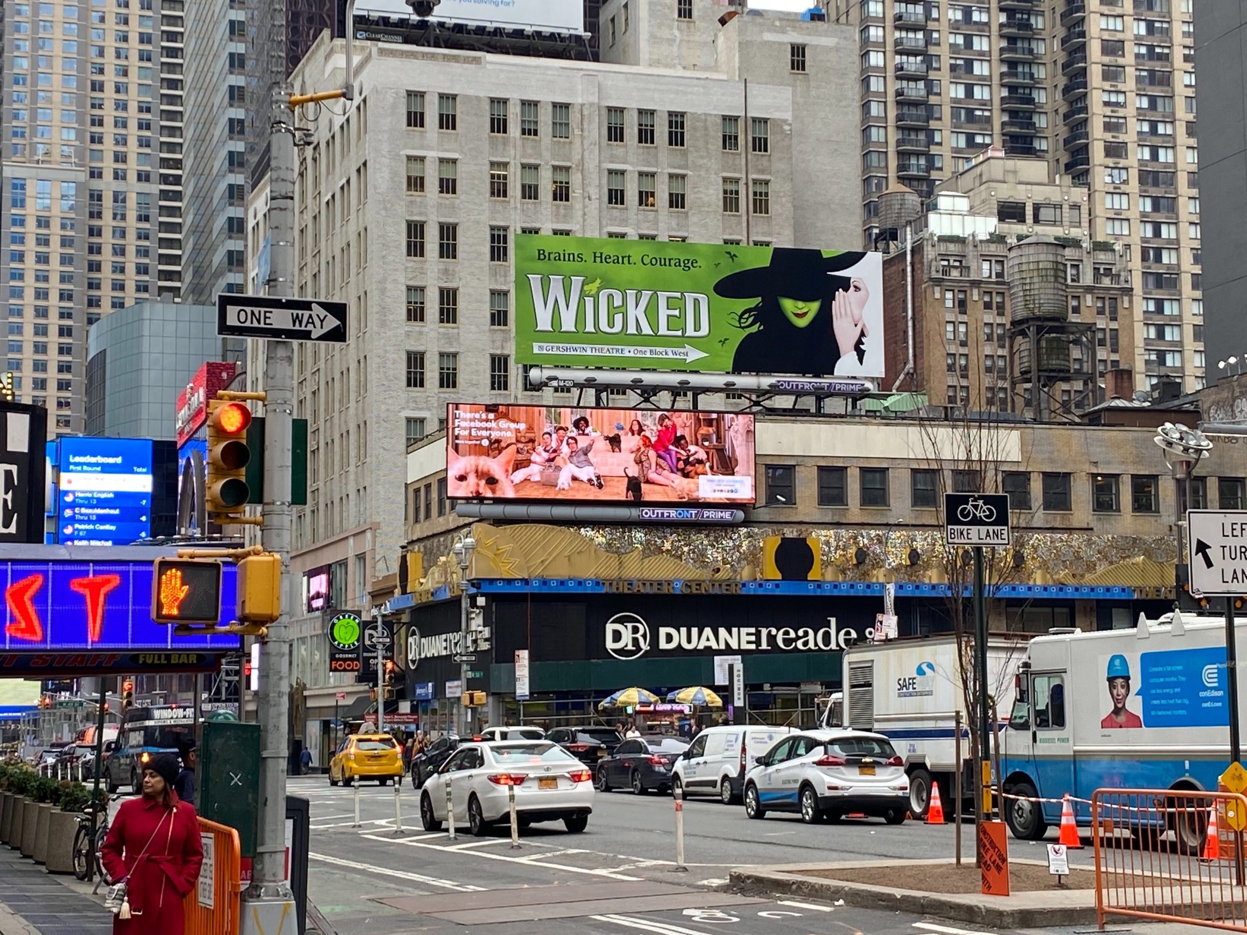 PHOTO: A busy intersection with a billboard for “Wicked.” Photo by The Signal Executive Editor Emily Nichelle Wolfe