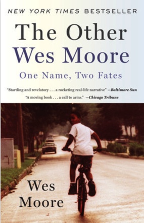 Photo: The cover of Wes Moore's, "The Other Wes Moore: One Name, Two Fates," shows an African American boy riding his bicycle down a street, looking back toward the viewer.