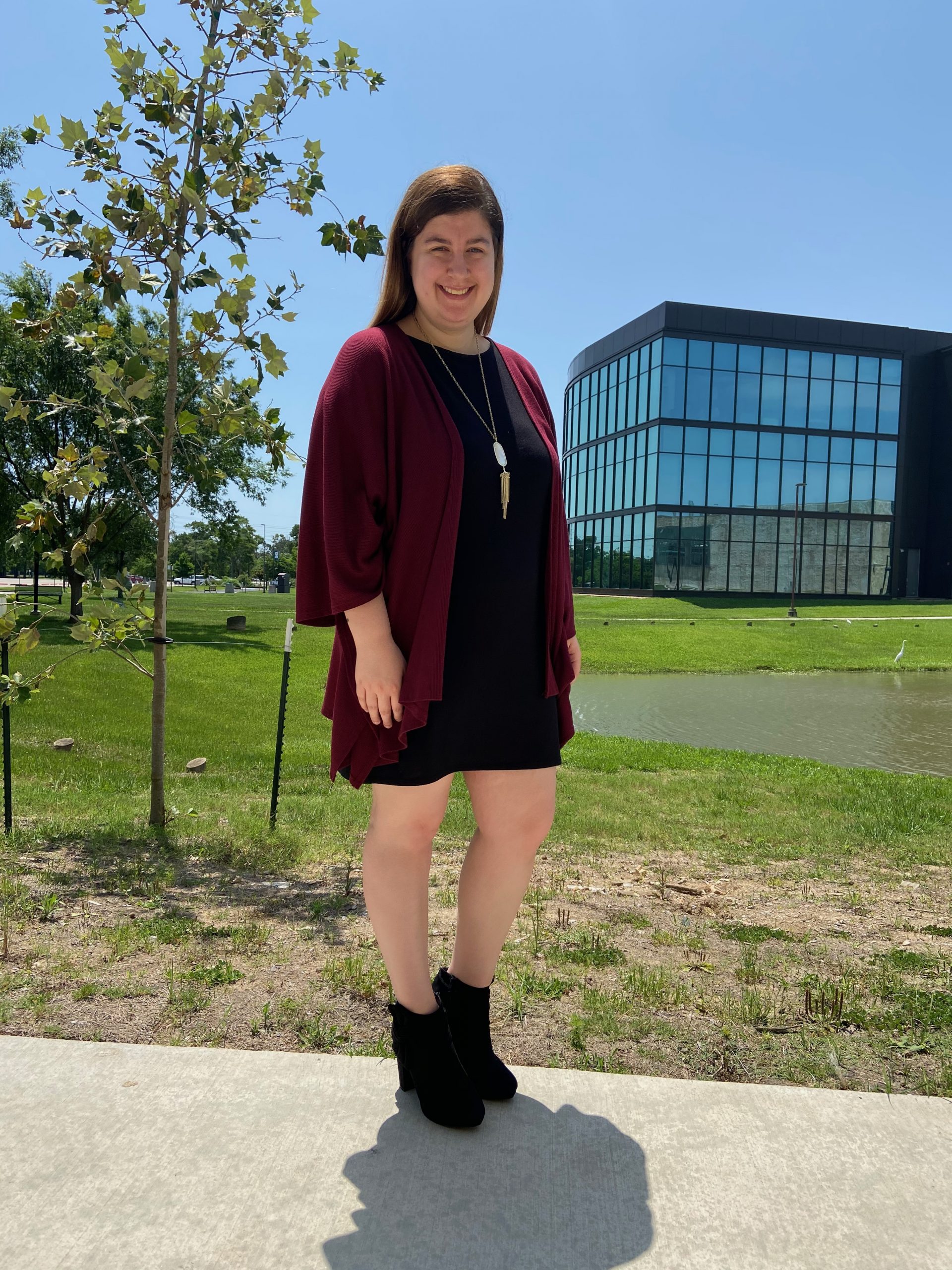 PHOTO: Signal reporter wearing a black dress, a cardigan, black booties and a necklace for an office look. Photo by The Signal reporter Jenna Schaub