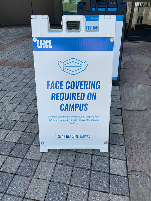 PHOTO: A COVID-19 sign that explains that face coverings are required on-campus. Photo by The Signal reporter Jenna Schaub.