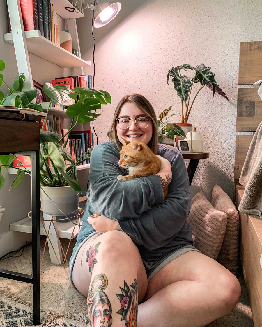 PHOTO: Jessica Kunzat around her plants and holding her cat Tigger. Photo by The Signal Audience Engagement Editor Jessica Kunzat.