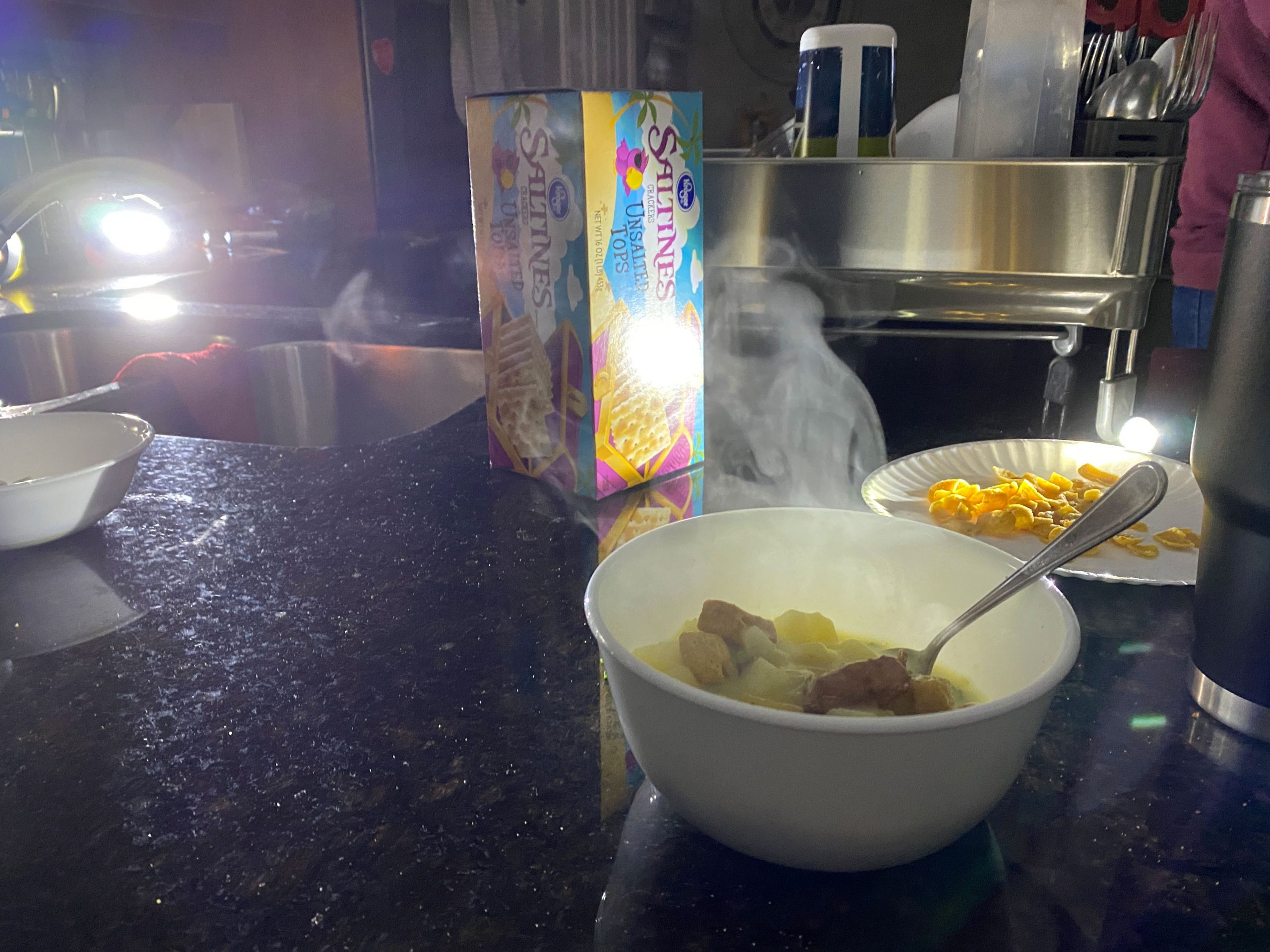 PHOTO: Soup in a white bowl is on a black counter. In the back are saltine crackers. Photo by The Signal Executive Editor Miles Shellshear.