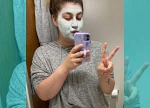 PHOTO: Jenna Schaub wearing a face mask and posing for a selfie. Photo by The Signal reporter Jenna Schaub.