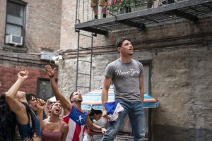 PHOTO: Anthony Ramos in the middle of a courtyard scene in "In The Heights." Photo courtesy of Macall Polay and Warner Bros. Entertainment Inc.
