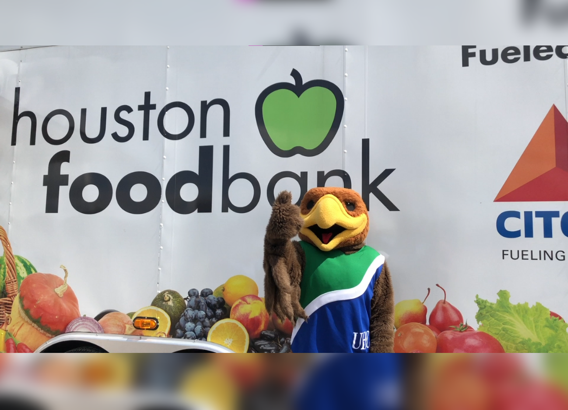 PHOTO: Hunter the Hawk stands in front of the Houston Food Bank's mobile food pantry. Photo by The Signal Executive Editor Miles Shellshear.