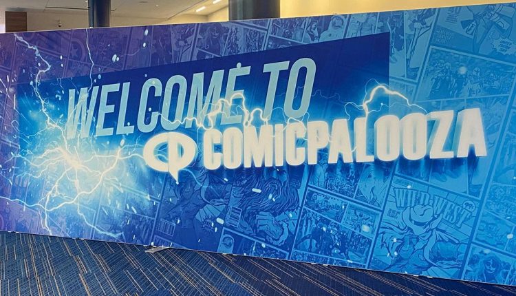 PHOTO: A blue photo wall with the phrase "WELCOME TO COMICPALOOZA" in the center. Photo by Editor-in-Chief Emily Nichelle Wolfe.