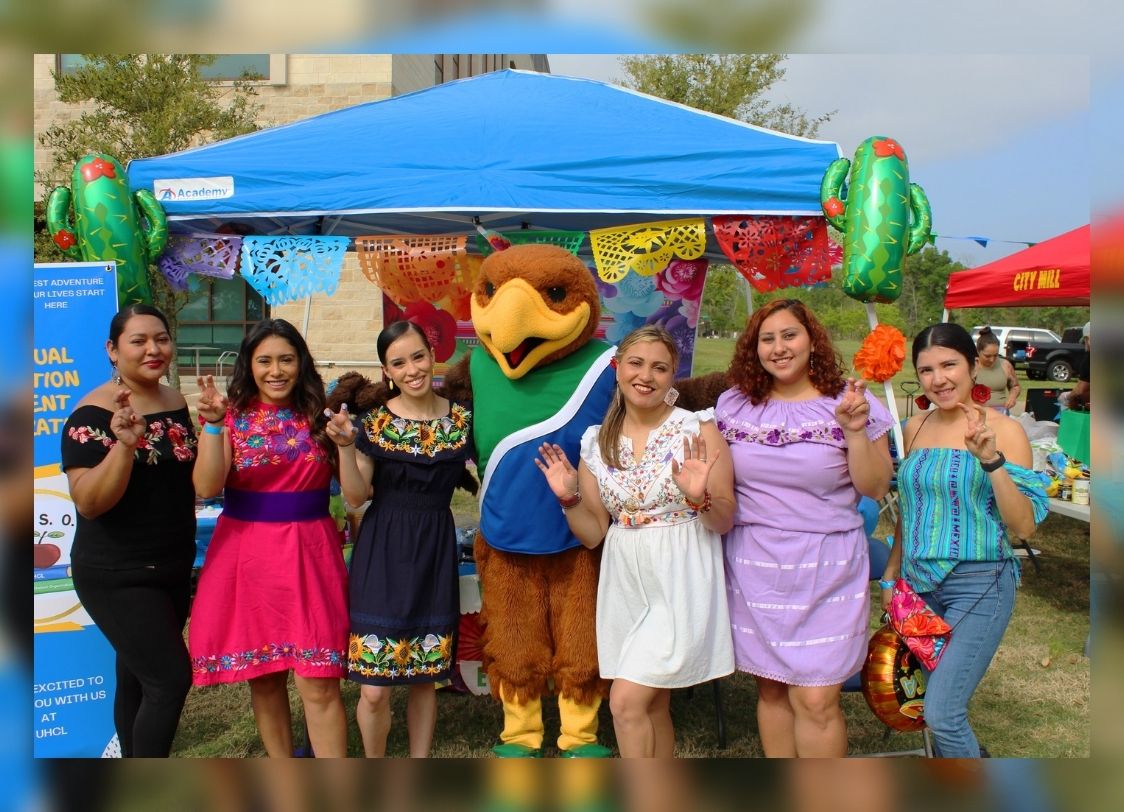 PHOTO: Members of the Chili Con BESO team pose with Hunter the Hawk (from left to right) Stephanie Martinez, vice president of the Bilingual Education Student Organization (BESO) and interdisciplinary studies major with EC-6 certification and bilingual supplement, Celeste Recendez, member of BESO and interdisciplinary studies major with EC-6 certification and bilingual supplement, Maria Fonseca, member of BESO and interdisciplinary studies major with EC-6 certification and bilingual supplement, Hunter the Hawk, UHCL mascot, Any Melendez, president of BESO and interdisciplinary studies major with EC-6 certification and bilingual supplement, Melissa Garcia, member of BESO and interdisciplinary studies major with EC-6 certification and bilingual supplement, and Beatriz Short, member of BESO and interdisciplinary studies major with EC-6 certification and bilingual supplement. Photo by the Office of Student Involvement and Leadership.