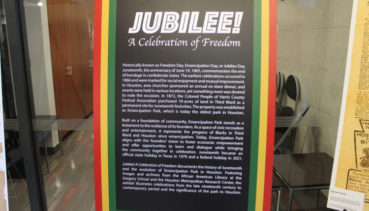 Inside the main building was an information set up for guest to learn. Three bars in red, gold, and then green surround the poster. The background is black and the text is white. Photograph by The Signal reporter Jared Cadore.