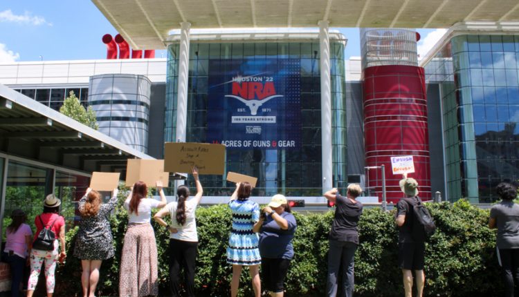 PHOTO: A group of protesters hold up signs in protest to the George R Brown Convention Center. Photograph by The Signal Managing Editor Cesar Cardenas.