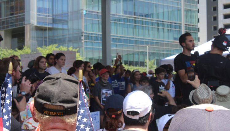 PHOTO: A Vietnam veteran and a crowd of protesters looks on at the stage at Discovery Green where David Hogg is speaking. Photograph by The Signal Managing Editor Cesar Cardenas.