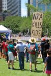 PHOTO: A protester walks through a crowd with a large sign that reads “NRA Kills Kids” A sign held up by a protester with the words “ They were little kids” Photograph by The Signal Managing Editor Cesar Cardenas.