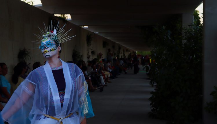 A catrina model on the runway in The Festival in the Garden at the Houston Botanic Garden.