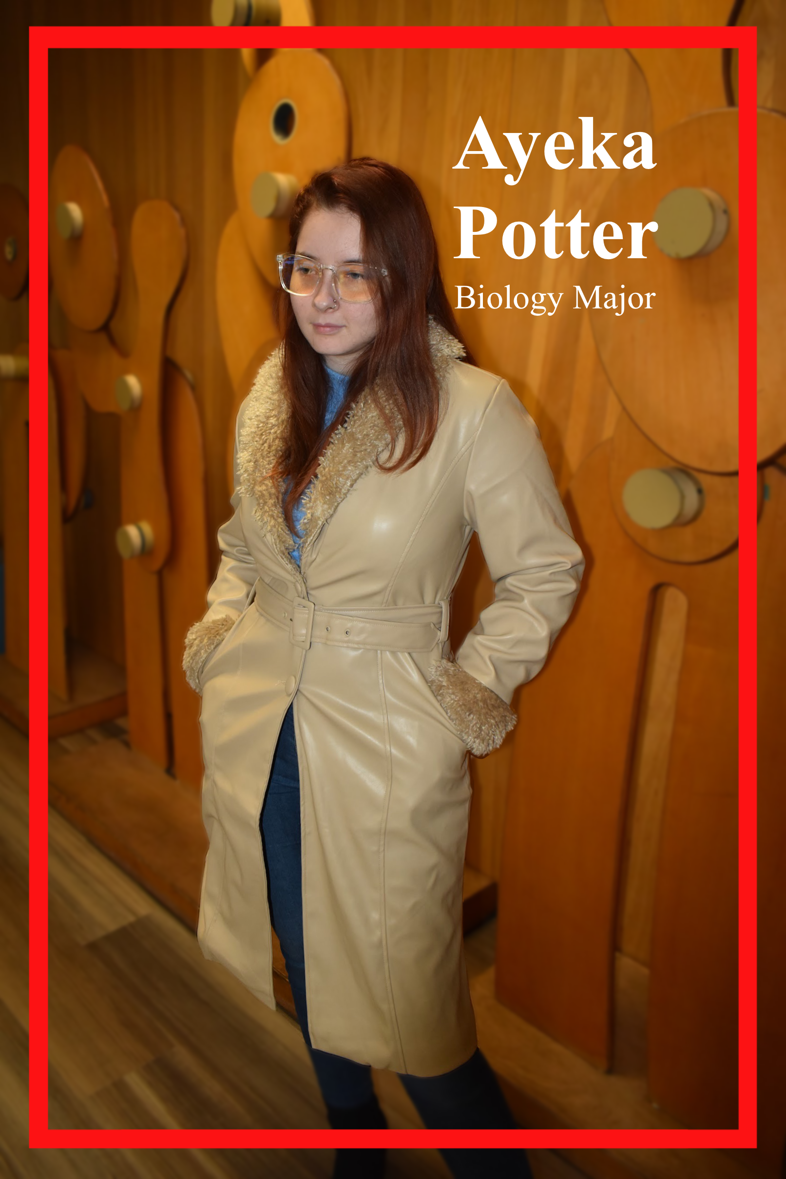 Ayeka Potter, Biology Major, stands posed in front of an art piece in Bayou Building. Donning on a Cream leather jacket with fur trim and tinted aviators.