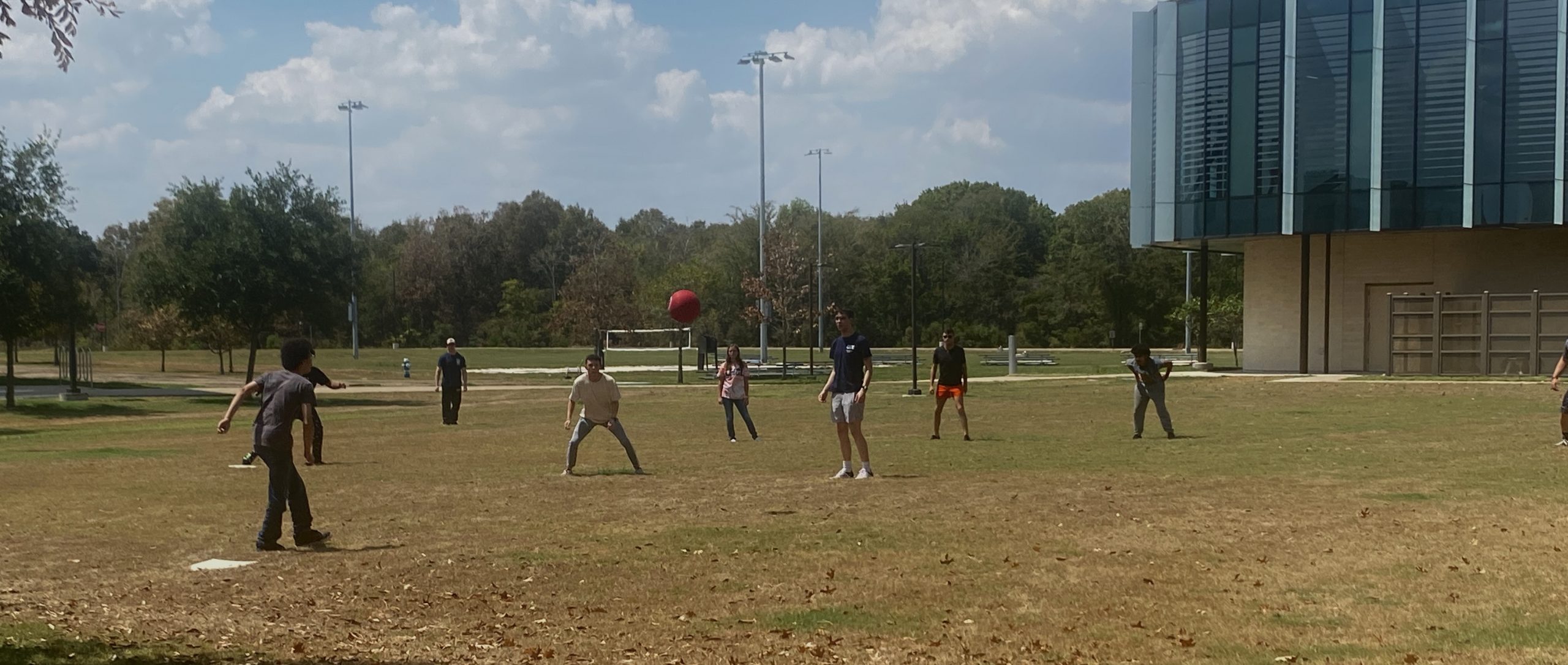 A group playing kickball outside.